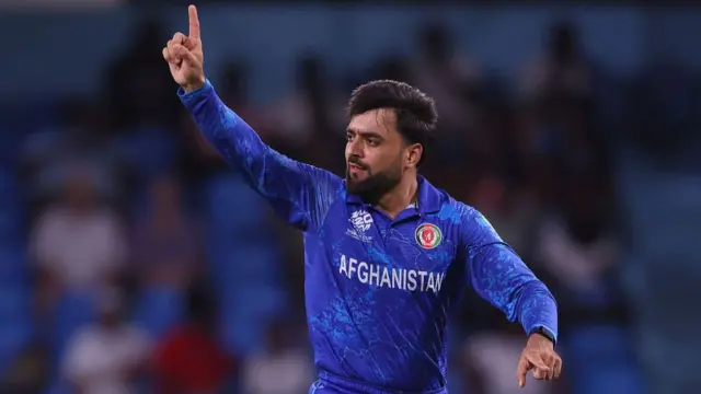 Rashid Khan celebrates taking a wicket