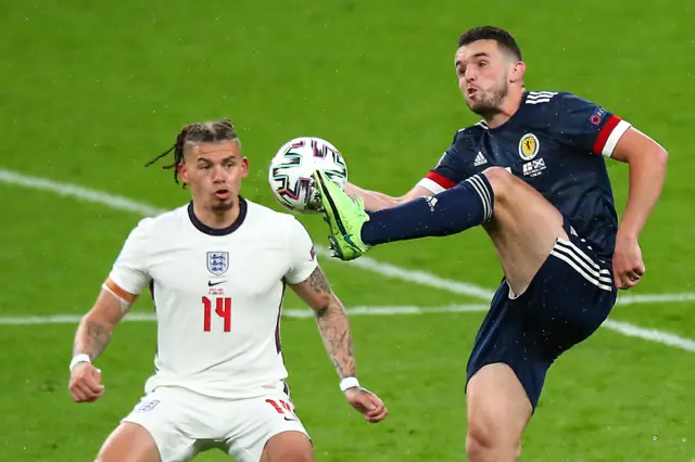 Kalvin Phillips of England and John McGinn of Scotland battle for the ball