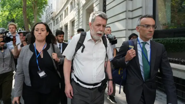 Gareth Jenkins (centre) leaves after giving evidence to the inquiry yesterday