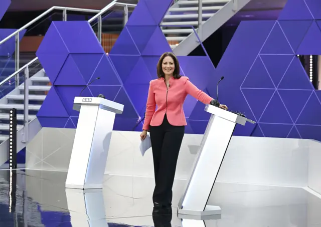 Mishal Husain standing between two podiums on the debate floor