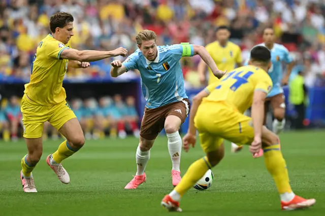 Illia Zabarnyi fights for the ball with Belgium's midfielder Kevin de Bruyne