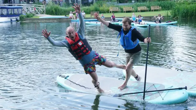 Liberal Democrat leader Sir Ed Davey falls off a paddleboard