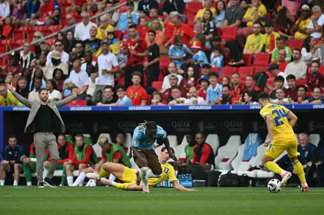 Oleksandr Tymchyk controls the ball as he is marked by Belgium's forward Jeremy Doku