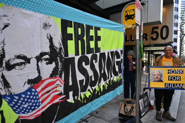 Assange supporter holds poster