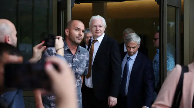 Julian Assange leaving the court in Saipan