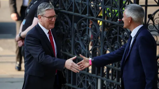 Keir Starmer greeted by Tim Davie