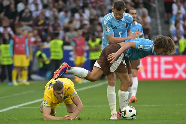 Wout Faes fights for the ball with Ukraine's forward Artem Dovbyk