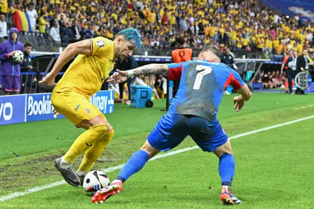 Andrei Ratiu fights for the ball with Slovakia's forward Tomas Suslov