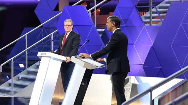 Keir Starmer and Rishi Sunak standing at their podiums.