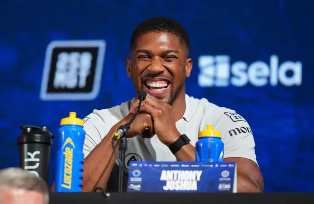 Anthony Joshua smiles and laughs