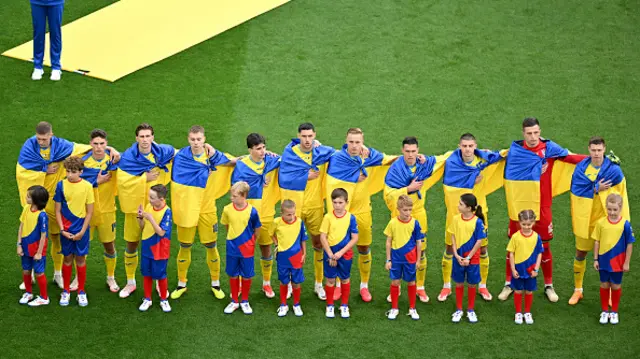 Players of Ukraine line up during the National Anthems