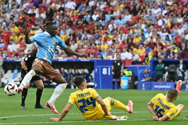 Oleksandr Tymchyk and Ukraine's defender  Vitaliy Mykolenko block a shot by Belgium's forward #22 Jeremy Doku