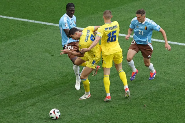 Amadou Onana fights for the ball with Ukraine's forward #09 Roman Yaremchuk