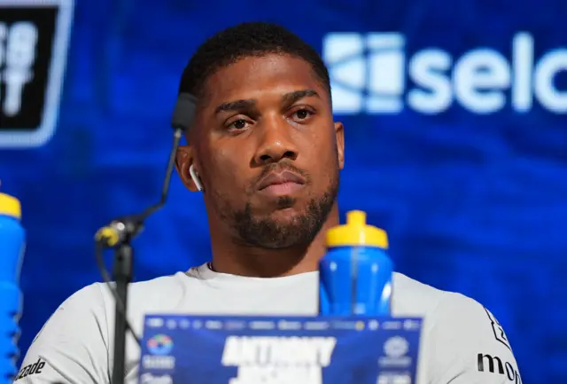 Anthony Joshua looks bored at a news conference