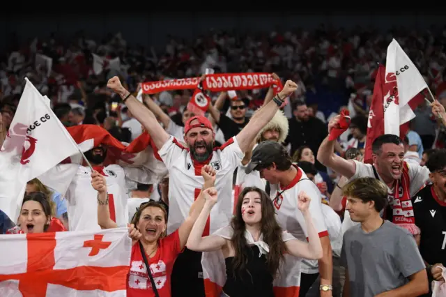 Georgia fans celebrate with flags and scarves
