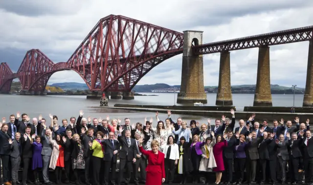 First Minister of Scotland Nicola Sturgeon (front, centre) with newly-elected SNP MPs in front of the Forth Rail Bridge in South Queensferry as the party marks its historic landslide general election victory in Scotland.