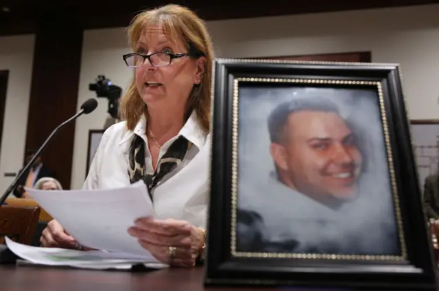 With a photo of her son, Corey Merrill, displayed on the table, Cheryl Juaire of Marlboro testifies before the Joint Committee of Marijuana Policy at the State House, Monday, March 20, 2017.