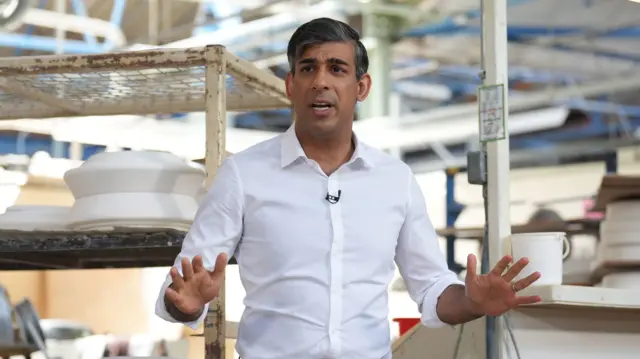 Sunak pictured talking within a pottery factory