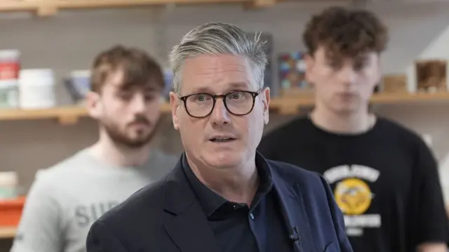 Keir Starmer speaking to a room on a campaign visit