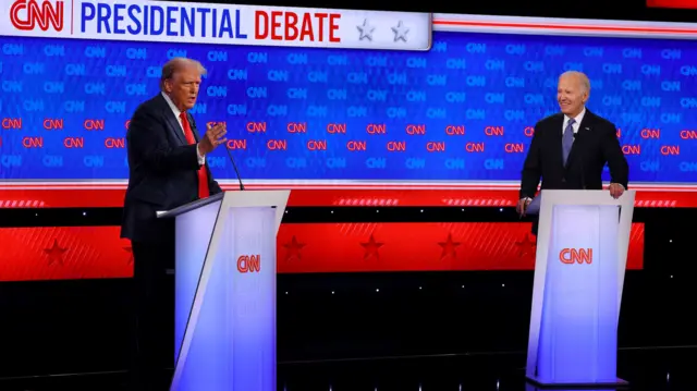 Donald Trump (left) seen expressing while answering a question at the debate and President Joe Biden (right) is seen smiling as Trump answers.