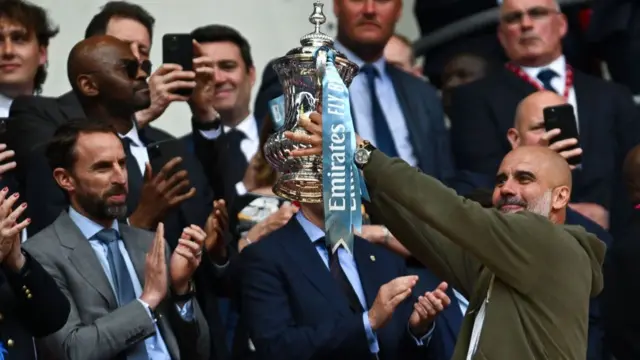 Pep Guardiola lifting the FA Cup