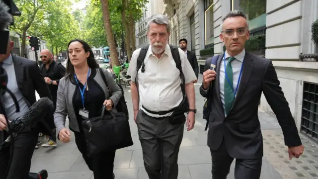 Gareth Jenkins walks into Aldwych House dressed in a white dress shirt ahead of being grilled in the Post Office inquiry