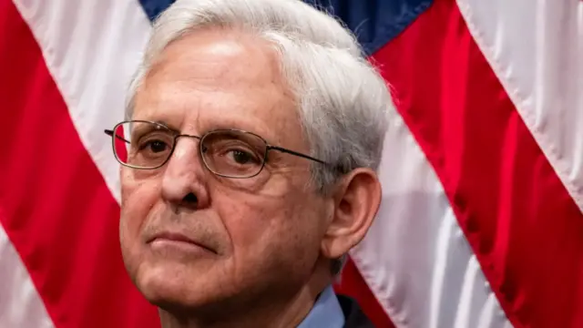 Merrick Garland in front of a US flag