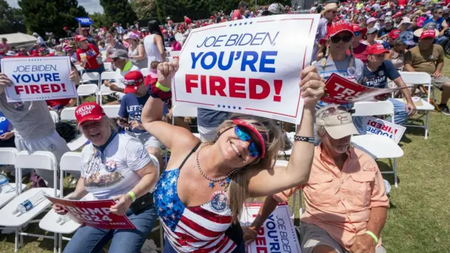 Trump supporter holds a sign reading "Joe Biden, you're fired!"