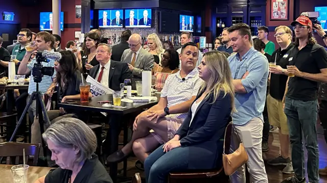 People sit in a bar