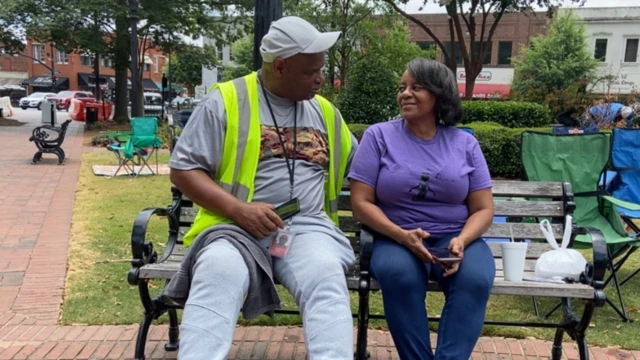 DeBorah Johnson and Andre Lorenza sit on a park bench