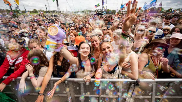 The crowd watching Squeeze perform on the Pyramid Stage, at the Glastonbury Festival