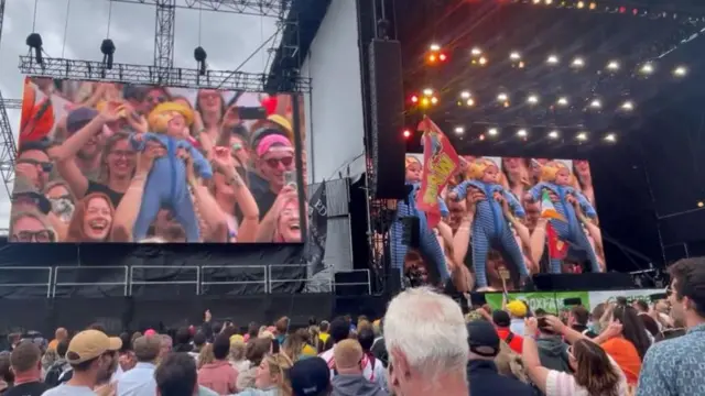 Big screens at Glastonbury showing ten-week-old baby boy