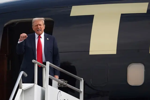 Donald Trump arrives in Atlanta and is seen disembarking from his plane.