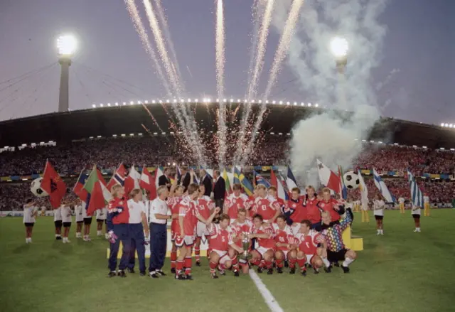 Fireworks go off as the Denmark team begin their celebrations