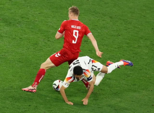 Ilkay Guendogan (R) of Germany and Rasmus Hojlund of Denmark