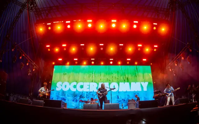 Photo of the band Soccer Mommy performing on stage at Glastonbury