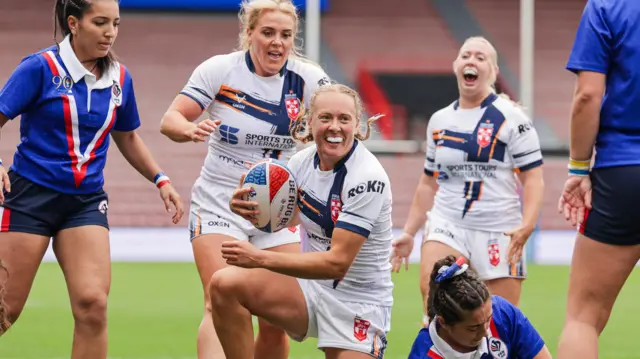 Anna Davies smiles after scoring a try