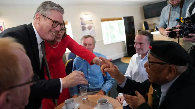 Sir Keir Starmer shakes hands with a veteran