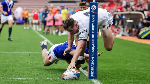 Jack Welsby stretches to score a try