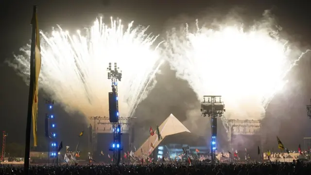 Fireworks shoot into the air above Glastonbury's Pyramid Stage