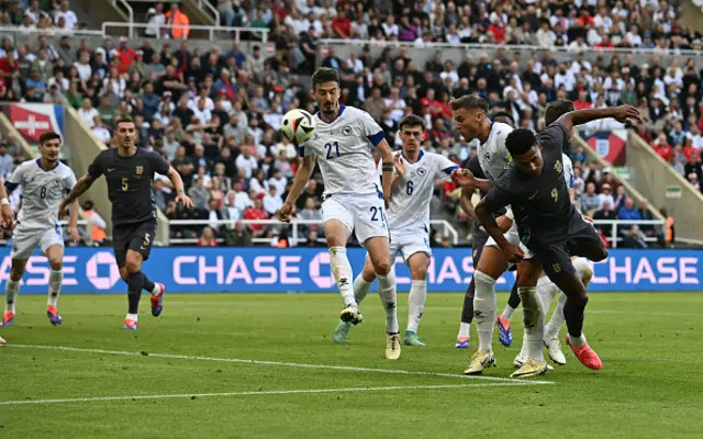 Ollie Watkins (R) headers goalwards but has his shot saved