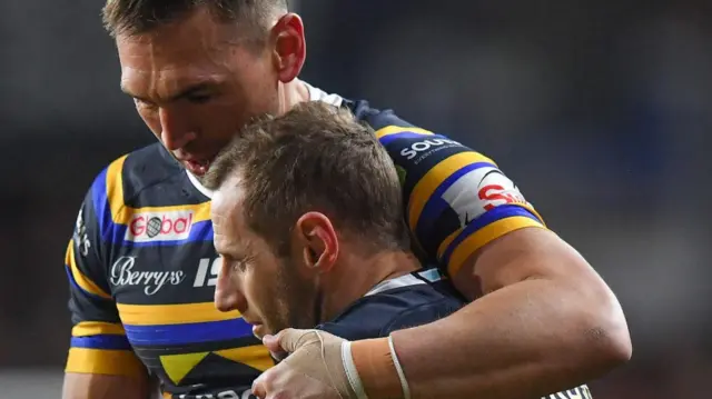 Sinfield holds his arm around Burrow