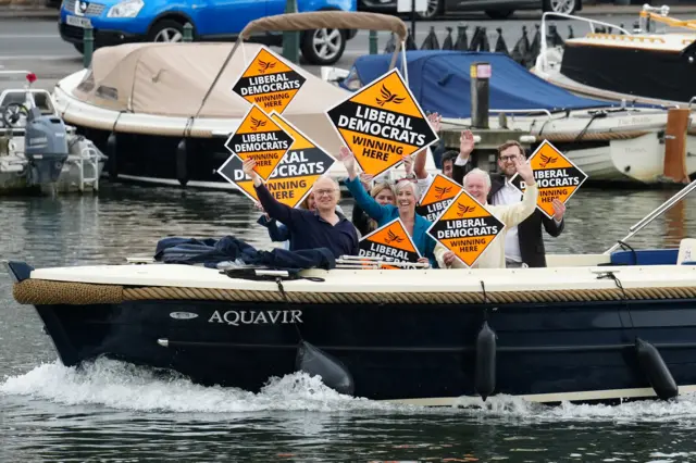 Lib Dem deputy leader Daisy Cooper photobombs Sunak while out campaigning