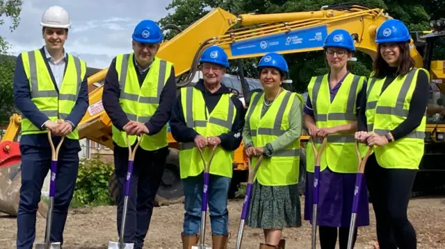 Six people in high-viz jackets