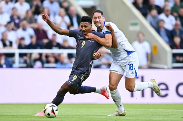 Ollie Watkins of England battles with Nikola Kati