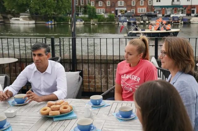 Rishi Sunak being photobombed by the Lib Dems while out on the campaign trail