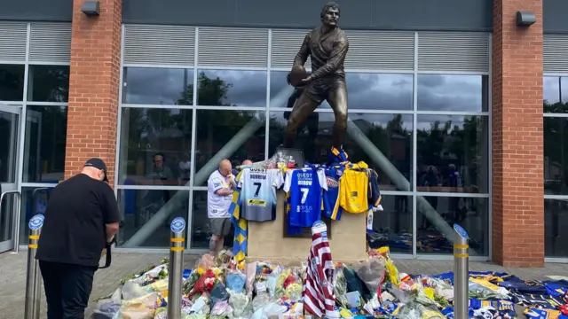 Tributes left at statue