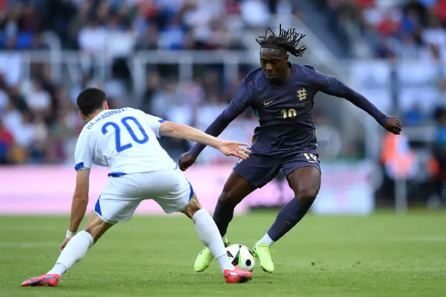 Eberechi Eze of England runs with the ball under pressure from Haris Hajradinovic