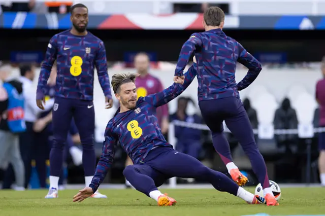 Jack Grealish tackles James Maddison warming up