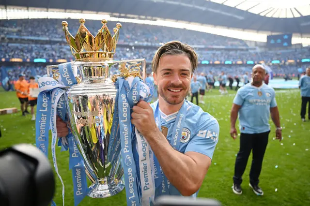 Jack Grealish of Manchester City poses with the Premier League trophy